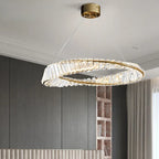 Modern crystal chandelier with textured circular rings suspended by thin wires, elegant and luminous.