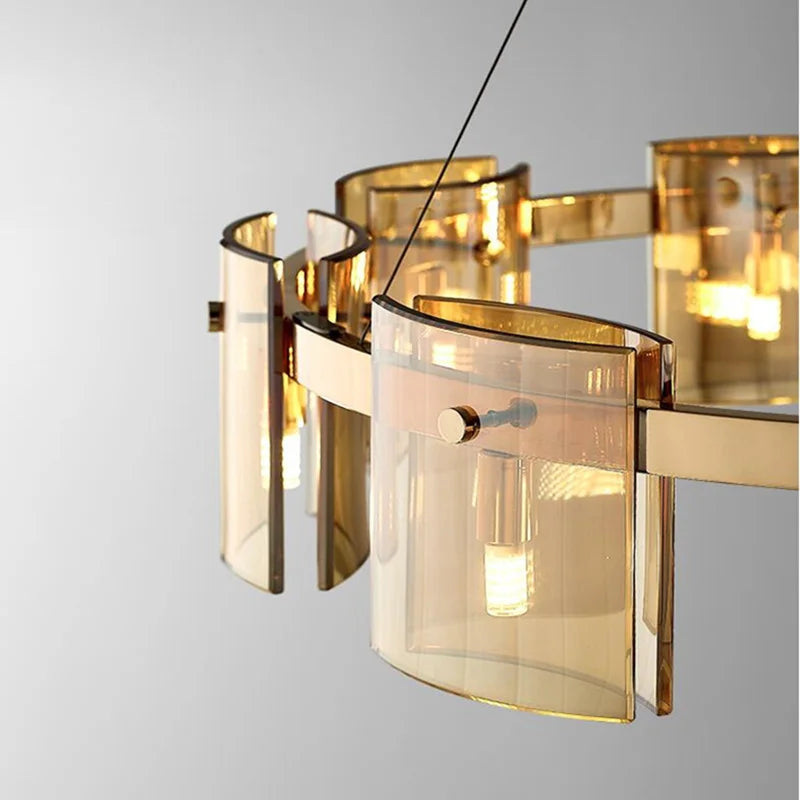 Elegant Scandinavian chandelier with gold accents, curved glass panels, and glowing LED bulbs.