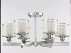 Modern chrome chandelier with five cylindrical glass crystal shades, each holding a white candle-style light.