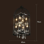 Art Deco crystal chandelier with black iron cage, exposed bulbs, and elegant hanging crystal accents.