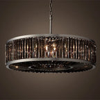 Maison Ornate vintage modern chandelier with dark metal frame, vertical glass panels, and warm glowing crystal accents.