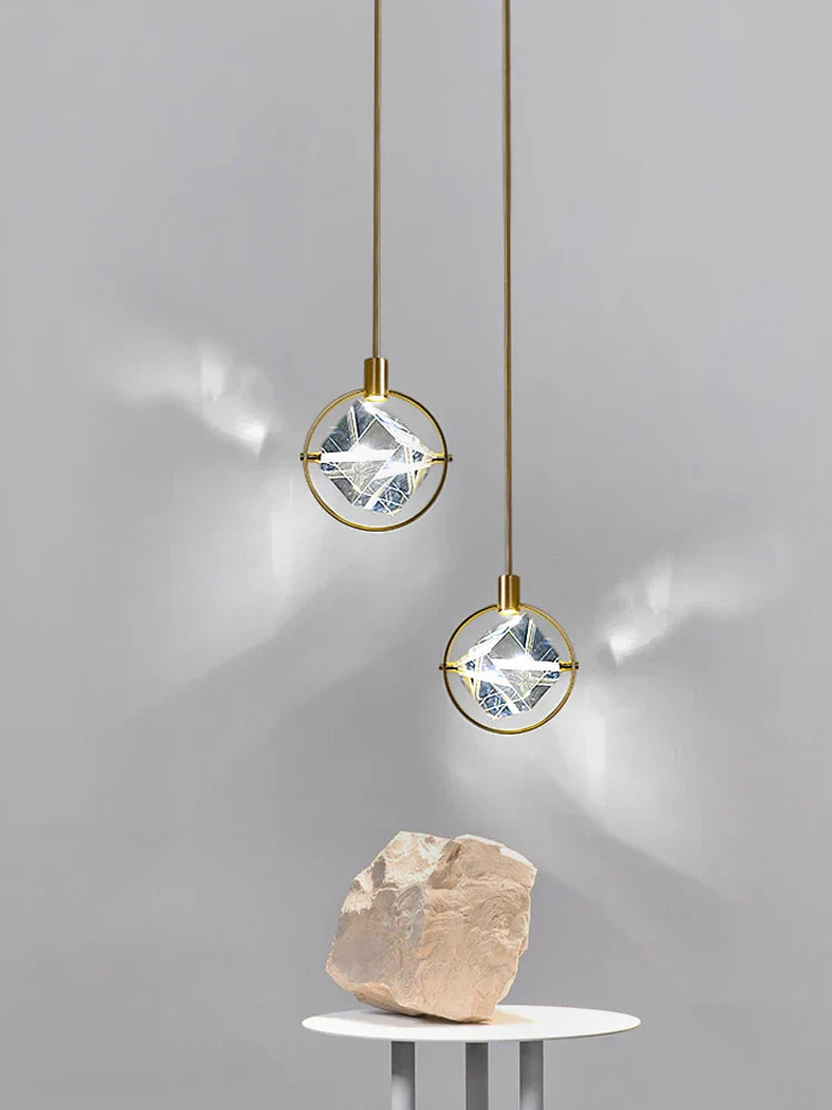Two luxurious Nordic postmodern crystal chandeliers with gold accents and glass globes, ornate design.