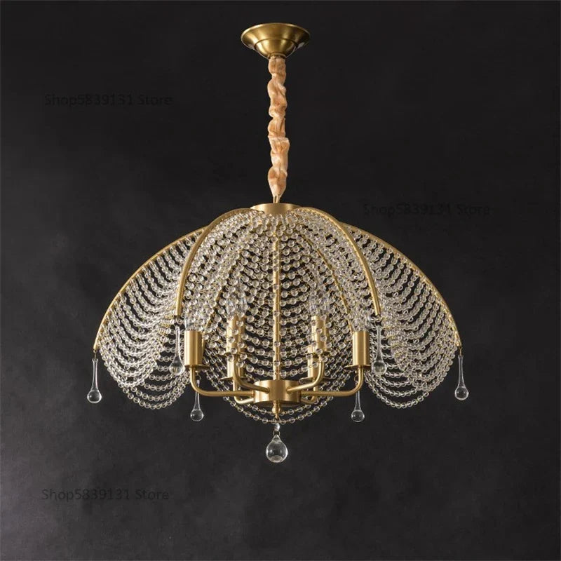 Nordic-style golden chandelier with copper accents, dome frame, crystal beads, and teardrop ornaments.