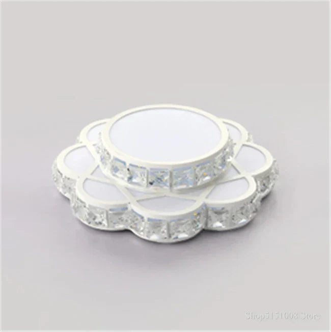 Round, white flower-shaped chandelier with crystal borders and a smaller matching upper tier.