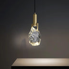 Modern minimalist chandelier with copper fixture and clear faceted crystal shade, elegant bedroom lighting.