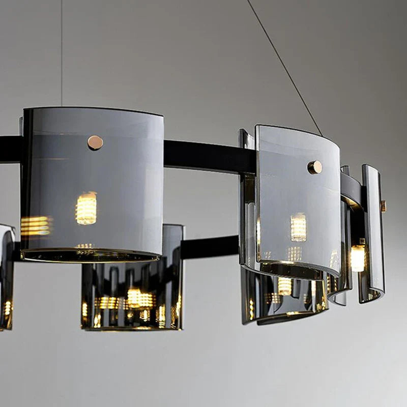 Elegant Scandinavian chandelier with curved smoked glass panels and warm LED bulbs suspended by thin wires.