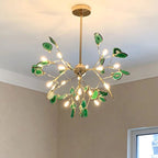 Maison Ornate Flower-Shaped Crystal LED Chandelier with gold branches and green crystal accents.