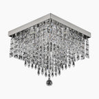 Modern square LED chandelier with chrome frame, tiered crystal prisms, and central round pendant.