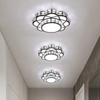 Three ornate golden crystal floral LED chandeliers featuring intricate crystal and metal accents, emitting bright white light.