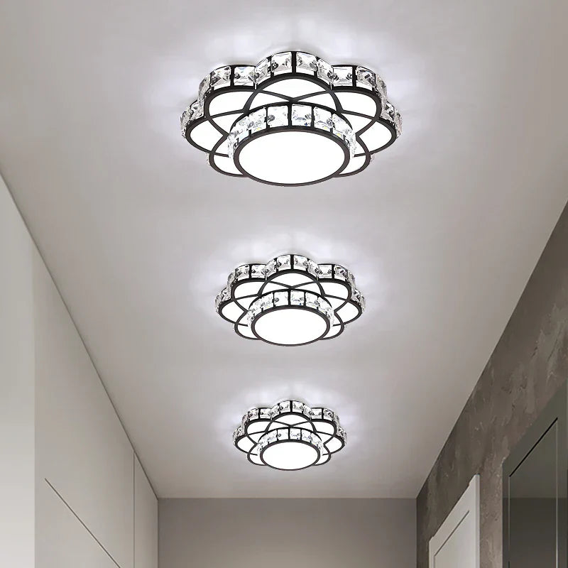 Three ornate golden crystal floral LED chandeliers featuring intricate crystal and metal accents, emitting bright white light.