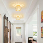 Two Maison Ornate Modern Crystal Chandeliers with glass shades cast decorative starburst light patterns.