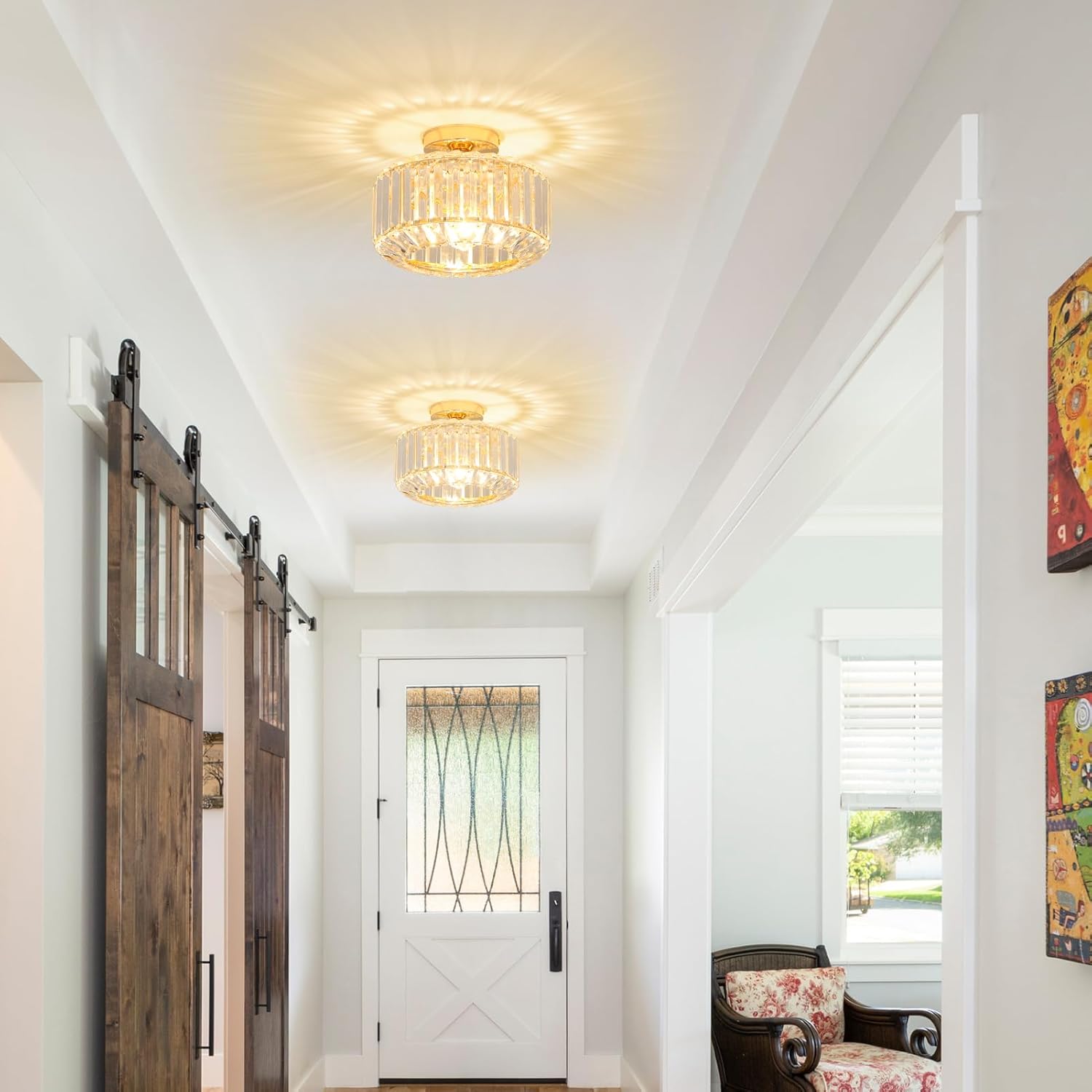 Two Maison Ornate Modern Crystal Chandeliers with glass shades cast decorative starburst light patterns.
