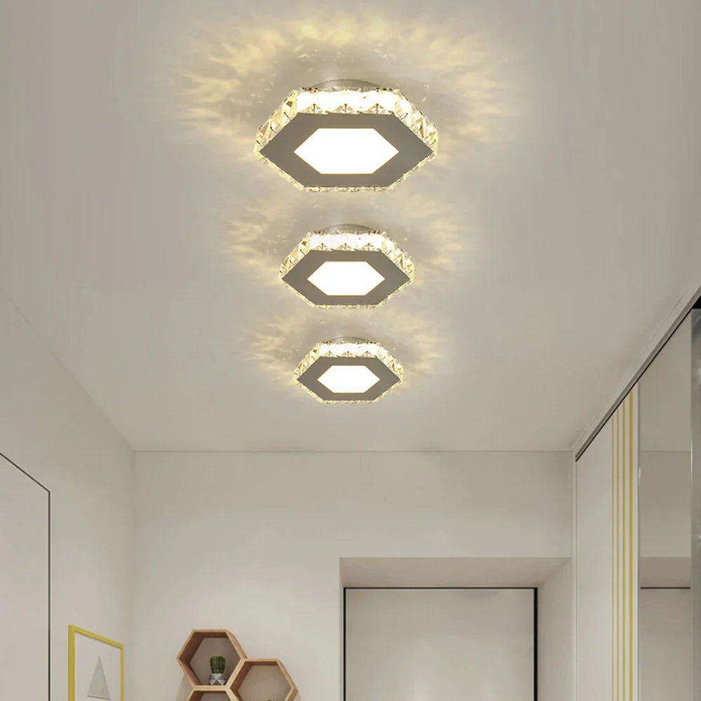 Three Maison Ornate Modern LED Crystal Flower Pendant Lights arranged in a row, emitting patterned light.