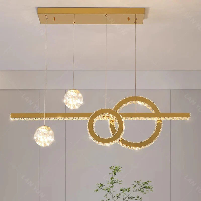 Modern crystal chandelier with three illuminated spheres and intersecting circles for elegant décor.