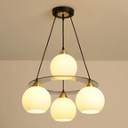 Three round crystal chandelier heads in a circular design, suspended by black rods, Art Deco-inspired.