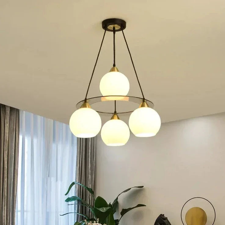 The Maison Ornate Modern Crystal Chandelier features three round heads and sparkling crystal details.