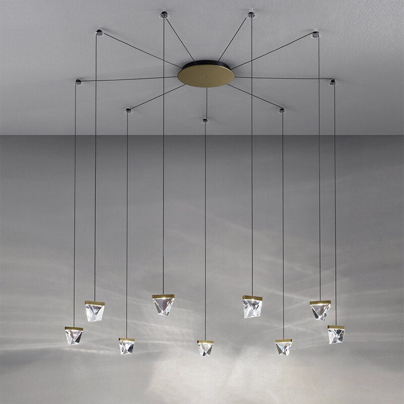 Modern crystal spider chandelier with eight geometric LED pendants on slim black cords, elegant reflections.