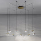 Modern crystal spider chandelier with eight geometric LED pendants on slim black cords, elegant reflections.