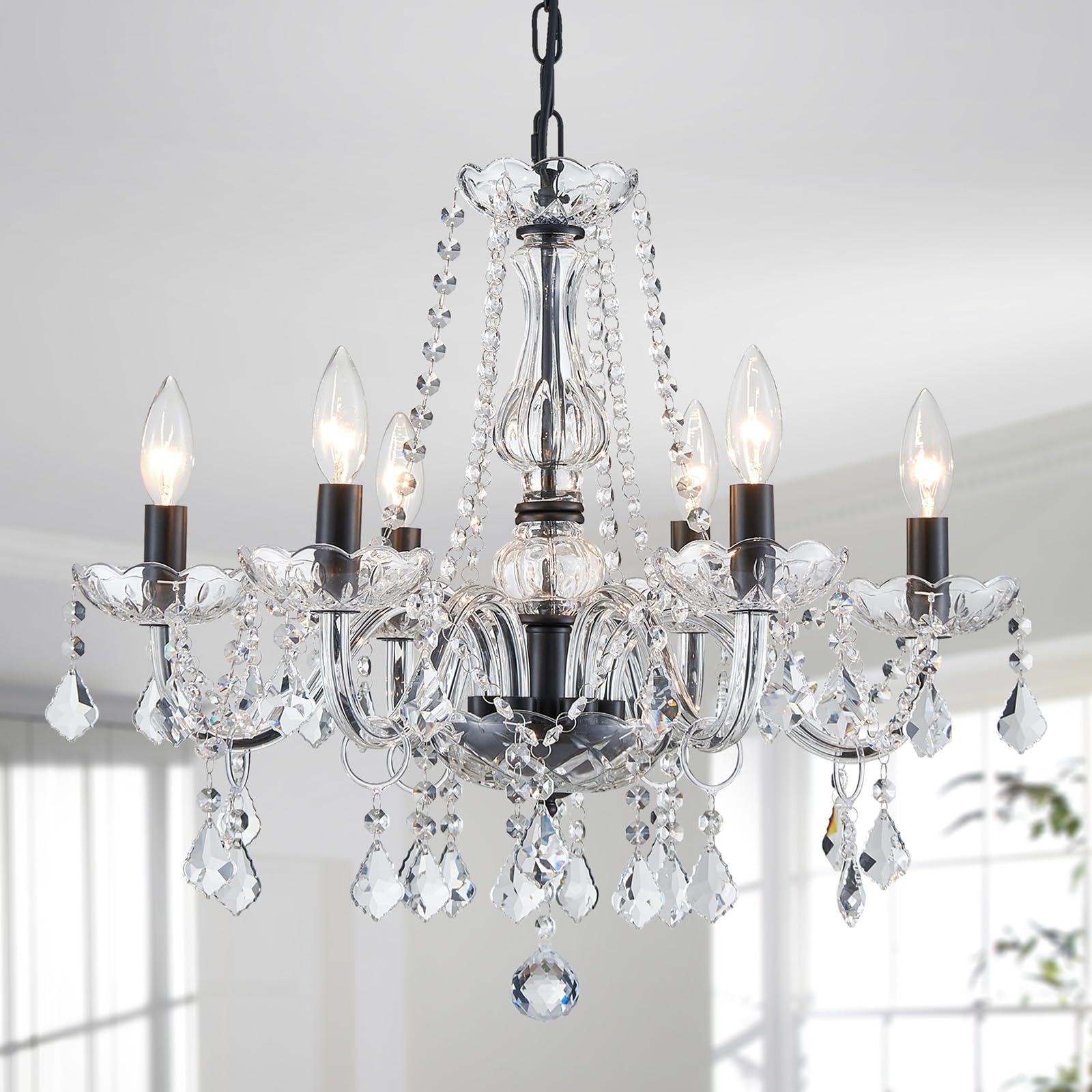 Six-light metal crystal chandelier with glass arms, sparkling prisms, ornate details, and black chain suspension.