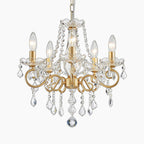 Five-light gold chandelier adorned with clear crystal beads and teardrop ornaments, elegant and modern.
