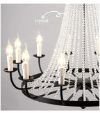 Maison Ornate Industrial Crystal Chandelier with lit candle bulbs, black iron arms, and acrylic crystals.