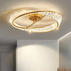 Gold-base chandelier with overlapping crystal rings emits warm light; elegant, modern, dimmable LED design.