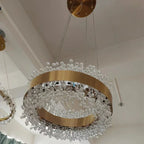 Circular gold LED chandelier with adjustable wires and clear crystal bead accents. Modern, elegant design.