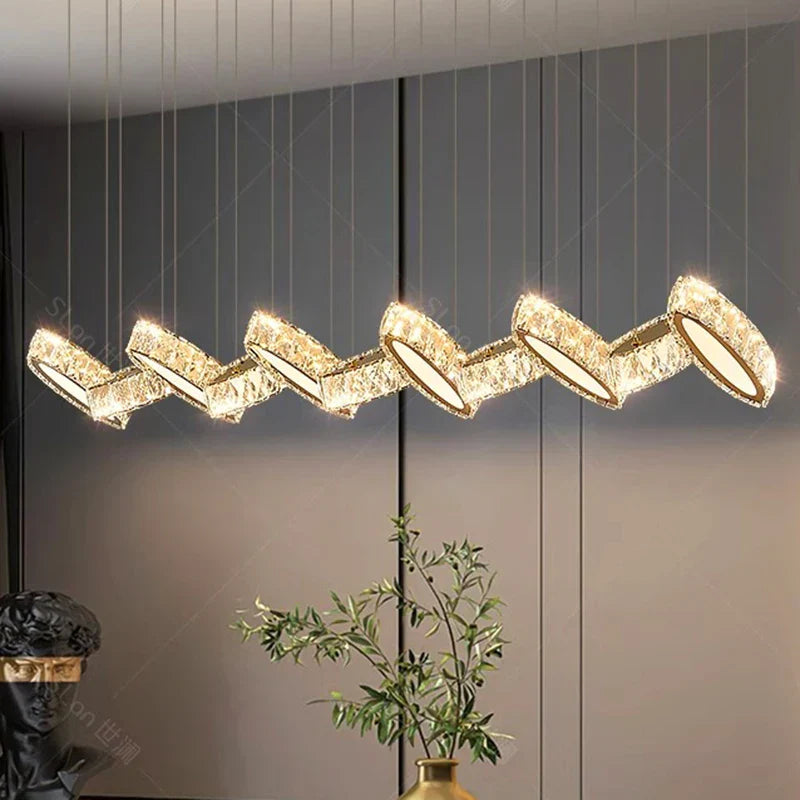 Modern crystal chandelier with zigzag LED geometric segments, gold accents, and elegant architectural design.