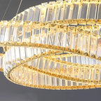 Close-up of Maison Ornate chandelier with gold metal bands and sparkling clear crystal panels.