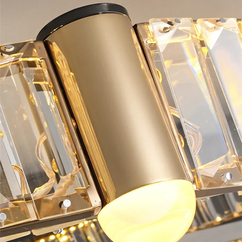 Close-up of Maison Ornate Nordic chandelier with LED rings, gold cylinders, frosted bulbs, crystal accents.