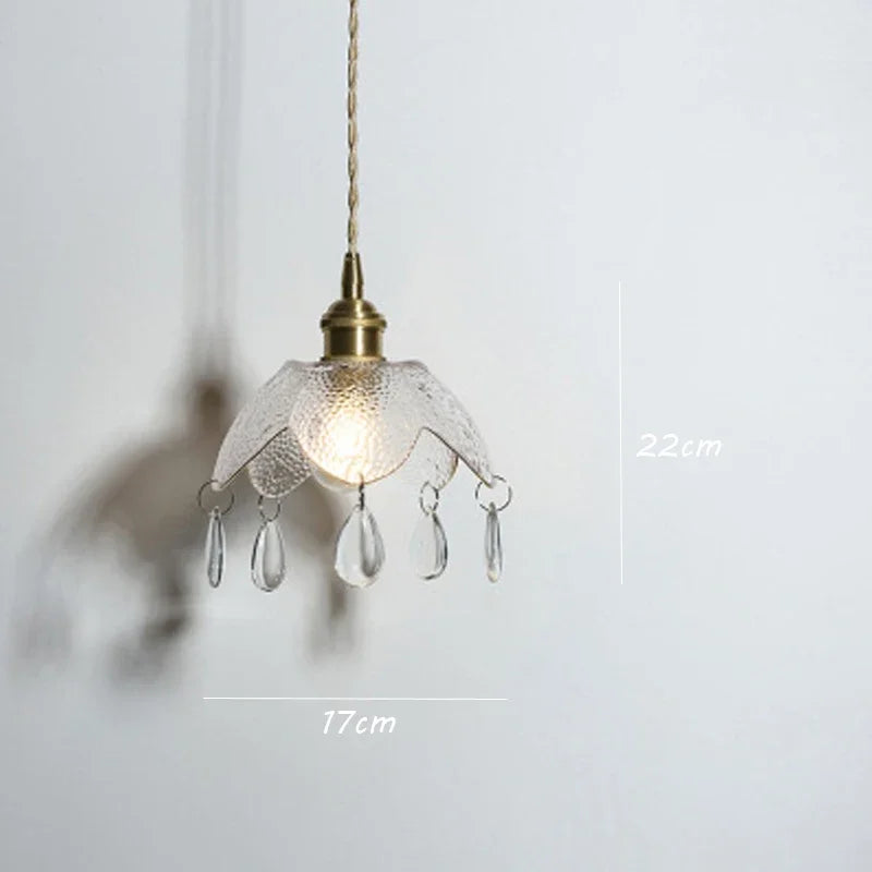 Vintage brass chandelier with textured flower glass shade and teardrop pendants, 22x17 cm.