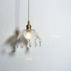 Vintage brass chandelier with textured flower glass shade and teardrop pendants, 22x17 cm.