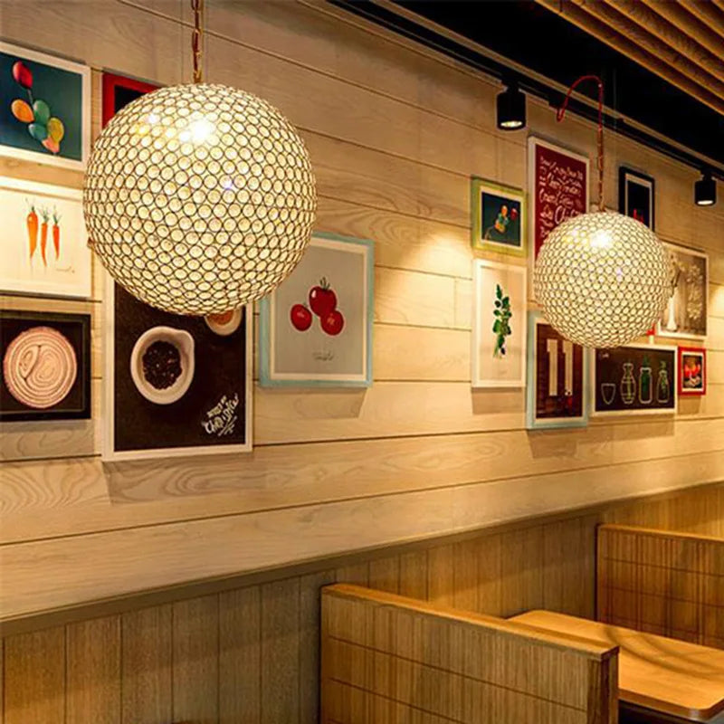 Maison Ornate's Round Crystal Ball LED chandelier and a honeycomb-patterned pendant lighting fixture.