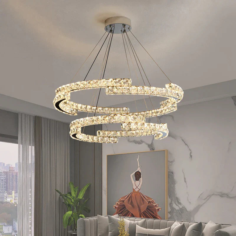 Maison Ornate Crystal Chandelier with stainless steel LED, two interlocking illuminated rings. Elegant lighting fixture.
