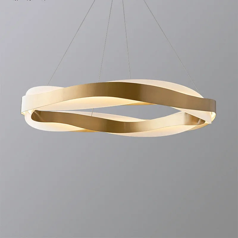 Twisted gold rings and crystal accents define this LED chandelier's elegant, modern silhouette. Dimmable glow.
