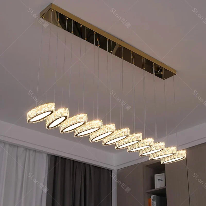Modern gold-mounted chandelier with ten crystal-like LED pendants in sleek, elegant row.