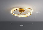 Circular gold and crystal LED chandelier with rings, 50x12 cm, emits a warm glow.