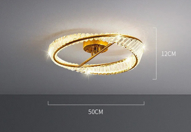 Circular gold and crystal LED chandelier with rings, 50x12 cm, emits a warm glow.