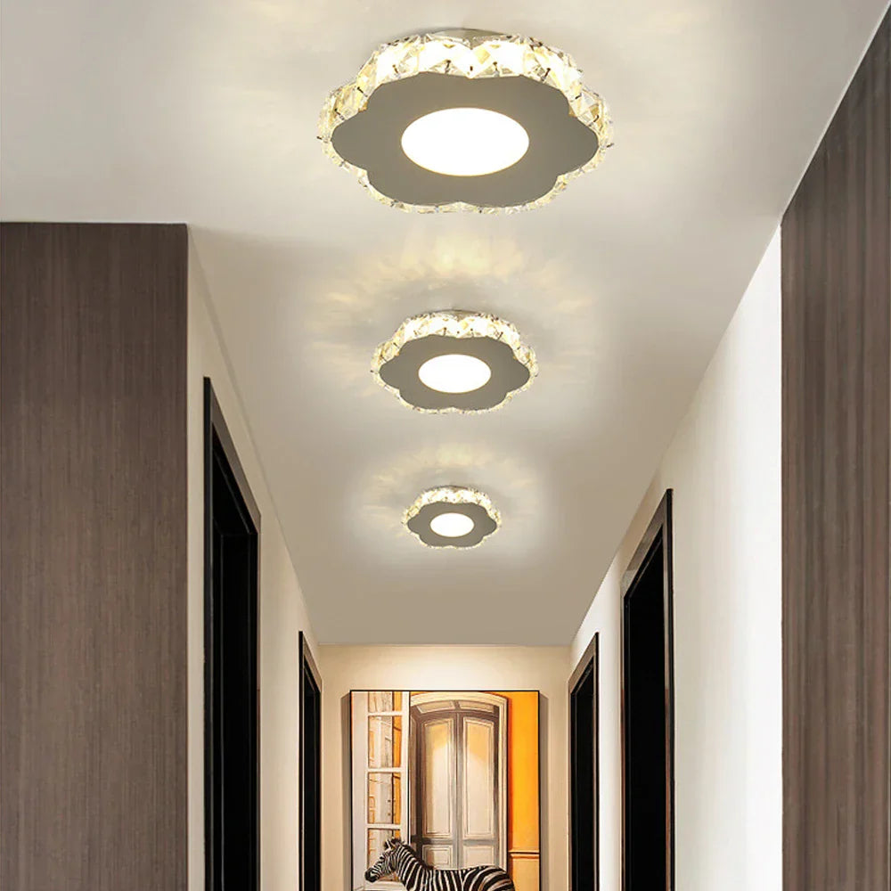 Three Maison Ornate Modern LED Crystal Flower Pendant Lights in a row, elegant glass detail.
