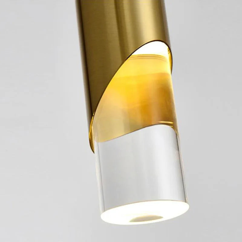 Sleek cylinder chandelier with gold and clear accents, warm white LED glow, modern elegance.