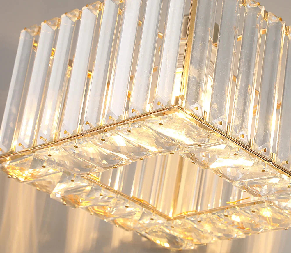 Art Deco crystal chandelier with square glass panels, gold accents, rope suspension, and warm lighting.