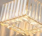 Art Deco crystal chandelier with square glass panels, gold accents, rope suspension, and warm lighting.