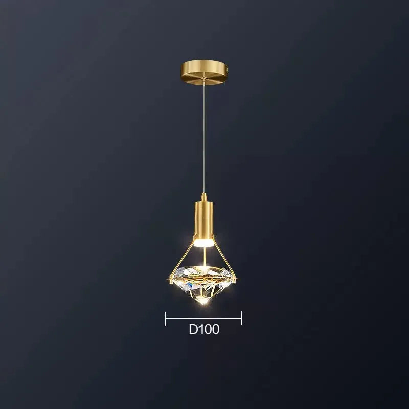 Ornate Nordic diamond crystal pendant with gold fixture and glass shade, warmly illuminated, elegant design.