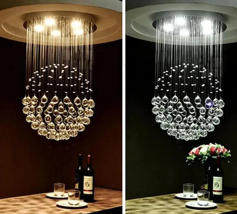 Side-by-side Maison Ornate Modern Spherical Crystal Chandeliers: one glowing warm yellow, one cool white.