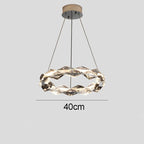 Twisted circular chandelier with integrated LED, metal suspension, and three-wire support, 40 cm diameter.