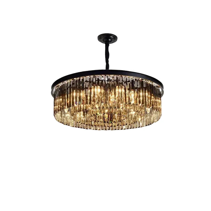 Elegant geometric chandelier with vertical crystal prisms on black frame, warmly illuminated with LED lights.