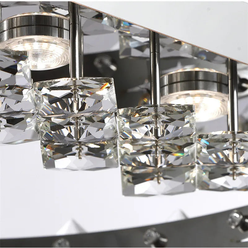 Close-up of Maison Ornate stainless steel crystal chandelier with square accents and integrated LED.