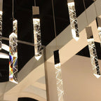 Maison Ornate Modern Crystal Chandelier with chrome frame, crystal pendants, and warm glow. Contemporary design.