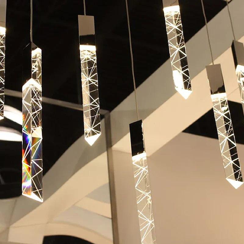 Maison Ornate Modern Crystal Chandelier with chrome frame, crystal pendants, and warm glow. Contemporary design.