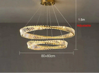Intertwined gold and crystal ring chandelier, adjustable height, modern design, remote control included.